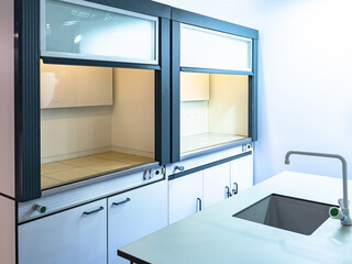 New laboratory furniture. Lab cabinets next to sink. Laboratory cabinets with niches for experiments. Concept - sale of furniture for a medical laboratory. Furniture for work of lab assistant.