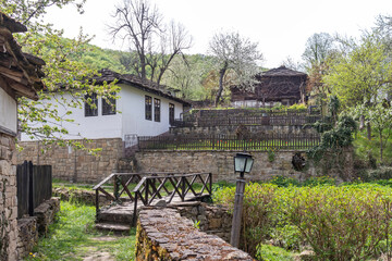 Fototapeta premium Typical street and old houses at historical village of Bozhentsi, Bulgaria