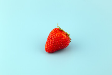Close-up of a strawberry isolated on light blue background