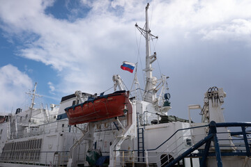 lifeboat aboard a large Russian ship. against the blue sky