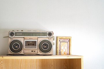 Retro outdated portable stereo boombox radio cassette recorder from the 80s on the shelf. Vintage...