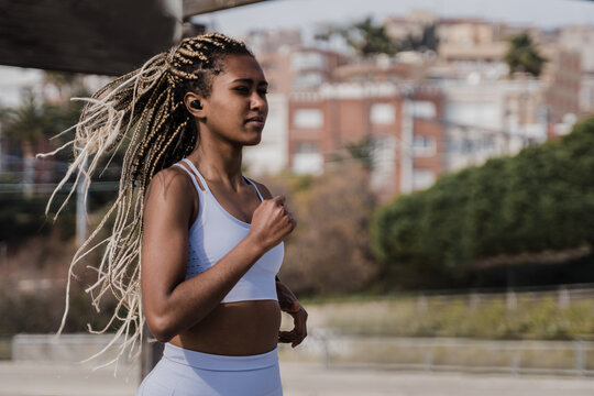 Young Black Woman Doing Workout Routine In Summer Time While Running Outdoor - Fitness And Sport Concept - Focus On Face