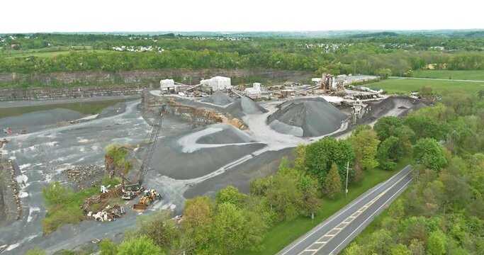 Panorama aerial view open-pit mine showing the various layers of quarrying extractive industry at open cast mining with lots of machinery