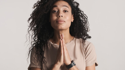 Beautiful dark haired African American woman hopefully praying o