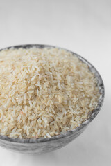Raw rice in grey ceramic bowl