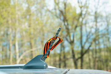 On the antenna of the car there is a St. George ribbon.