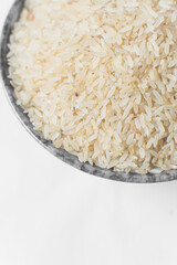 Raw rice in grey ceramic bowl