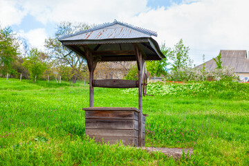 old wooden water well in village