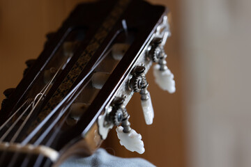 Fototapeta na wymiar Macro of Metal and Plastic Tuning Knobs on an Acoustic Guitar