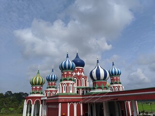 An eight domes mosque and clear blue sky in the evening. A beautiful views of the mosque to see.