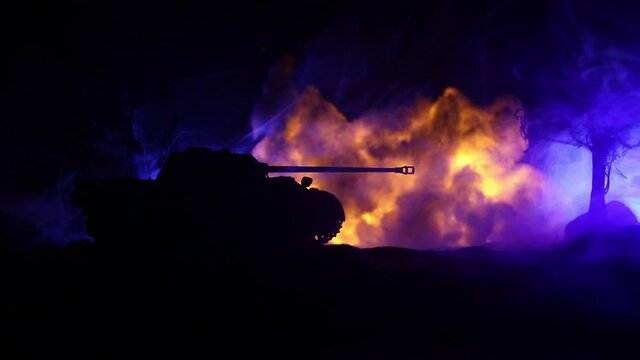 War Concept. Military silhouettes fighting scene on war fog sky background, World War Soldiers Silhouette Below Cloudy Skyline At night. Armored vehicle fight scene. Selective focus