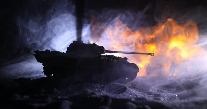 War Concept. Military silhouettes fighting scene on war fog sky background, World War Soldiers Silhouette Below Cloudy Skyline At night. Armored vehicle fight scene. Selective focus