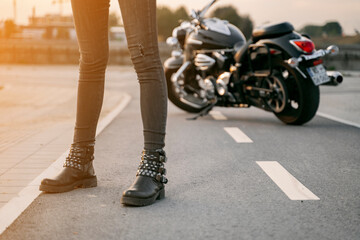 Fototapeta na wymiar Unrecognizable girl, legs only standing in front of motorbike