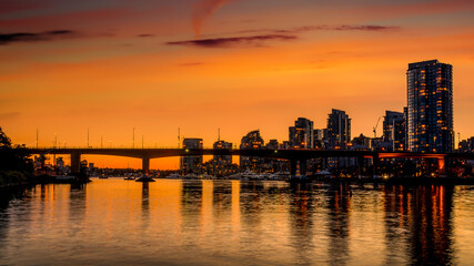Orange Sky from the Sun setting over the Cambie Bridge and the Vancouver Yale Town Skyline at the North Shore of False Creek, British Columbia, Canada