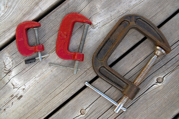 Red Antique Iron C Clamps on Weathered Wood