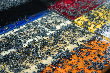 Vibrating screen, ore washing with liquid. Lots of small stones on the surface of the sieve