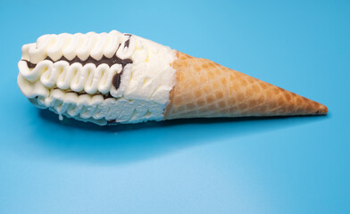 angle view vanilla and chocolate flavor ice cream cone on a blue background