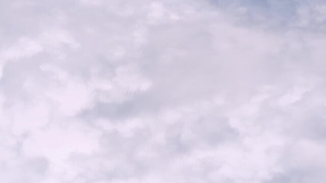 4K Time lapse, Gray and white rolling puffy clouds floating in the sky.