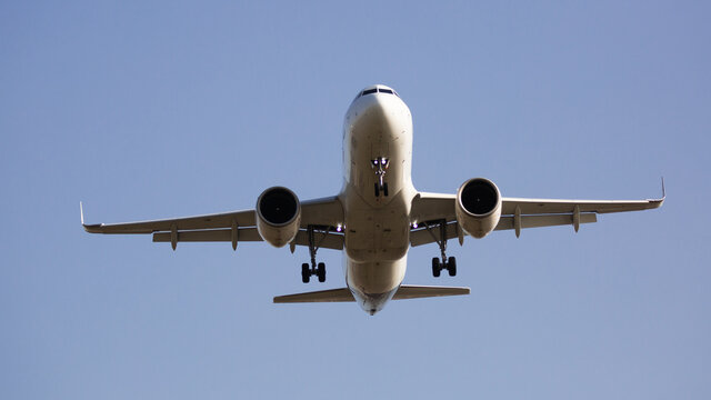 Image of passenger plane landing in airport afternoon at sunny day