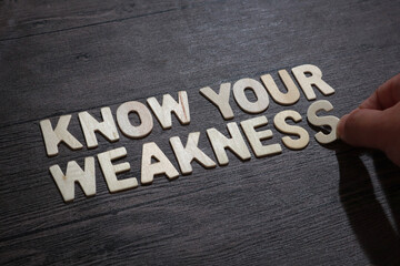 Know your weakness, text words typography written with wooden letter on black background, life and business motivational inspirational