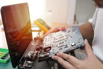 Close up of technician engineer trying to repairing broken laptop. Computer repairs and upgrade