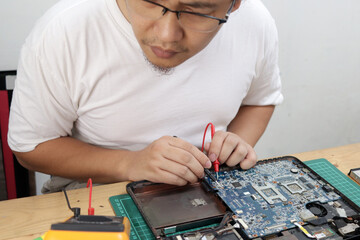 Close up of technician engineer trying to repairing broken laptop. Computer repairs and upgrade