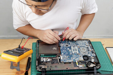 Close up of technician engineer trying to repairing broken laptop. Computer repairs and upgrade
