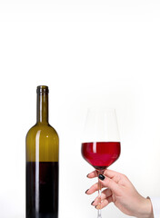Young woman holding glass of rose wine on white background. Hand with black polish.