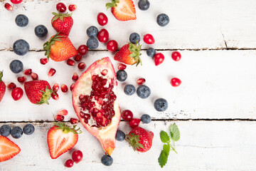 Various fresh forest berries on white background. Organic food concept.