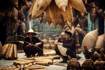 Craftsman making bamboo fish trap at old village, Hung Yen, Vietnam - obrazy, fototapety, plakaty