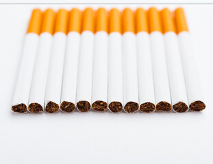 31 May of World No Tobacco Day, no smoking, close up of lined up full pile cigarette or tobacco on white background with copy space, and Warning lung health concept