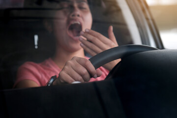 Sleepy woman While she was driving on the road. Concept of health and driving safety