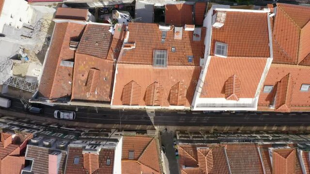 Aerial view above houses and cars on, in Sao Bento, in Lisbon, Portugal - overhead, drone shot