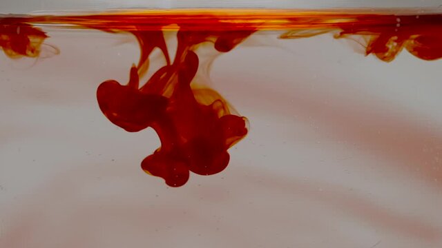 Slow Motion Macro Red Food Colouring Dropped Into Water