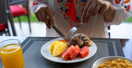 young woman eating healthy food for breakfast