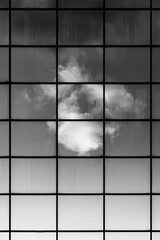 Sky reflecting in a modern architecture building in black and white