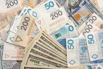 pile of us dollar and polish zloty banknotes as background