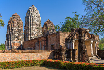 Ruins of the ancient Khmer temple Wat Si Sawai close-up on a sunny day. Sukhothai Historical Park, Thailand