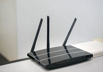 Wifi router with antennas on table. Internet or broadband concept.