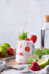 Tropical Caribbean cocktail mojito with coconut cream, strawberry and seltzer