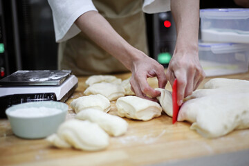 Fototapeta premium Chef preparing bread in kitchen