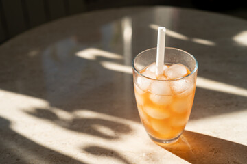 Glass of orange juice with ice and tonic