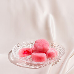 Mochi sweets on silk fabric. Copy space