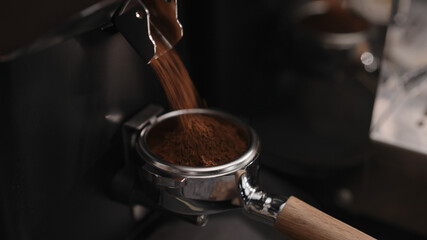 Closeup of grinding fresh coffee into pottomless portafilter