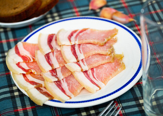 Close-up on a thin slices of fresh bacon in a restaurant