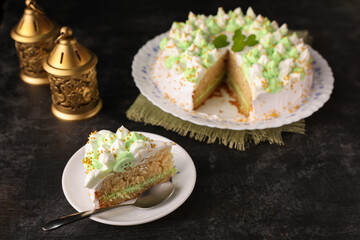 Cake piece Pistachio cake homemade baked vanilla sponge cake bakery Kerala India Sri Lanka birthday special occasion anniversary mint cake pastry with lemon yellow cream frosting of roses for Ramadan