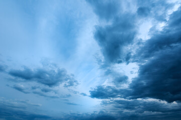 Fototapeta na wymiar Dramatic stormy cumulus clouds at the sky in spring dusk
