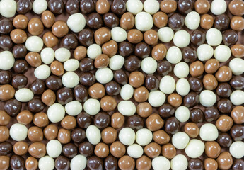 Background view of chocolate balls of different colors from above