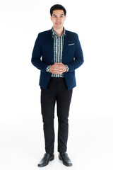 Full length portrait of a smiling positively young businessman in casual navy color suit standing on white background with both hands clasped.  Young businessman or entrepreneur concept.