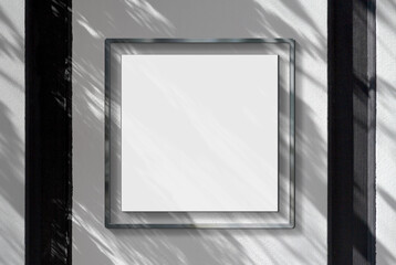 Metal frame hanging in street mockup. Template of a picture framed on a wall bathed in sunlight 3D rendering